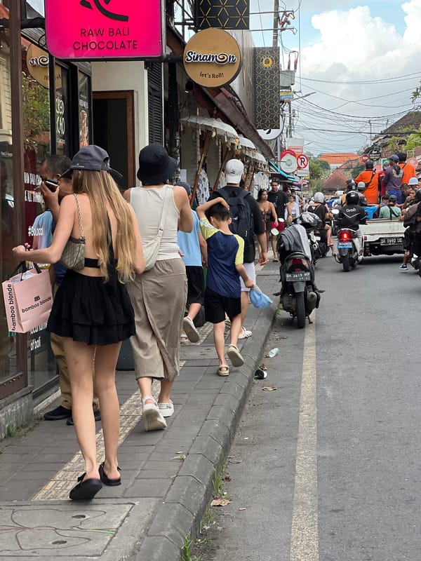 Tourist documents morning journey through Ubud's streets and temples