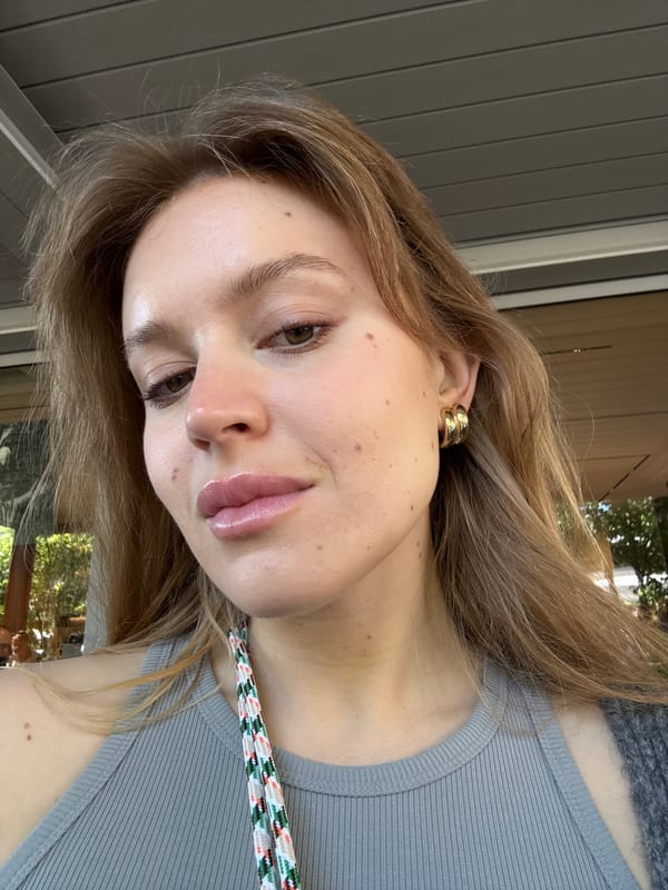 Woman photographed indoors in Rome wearing tank top, lanyard