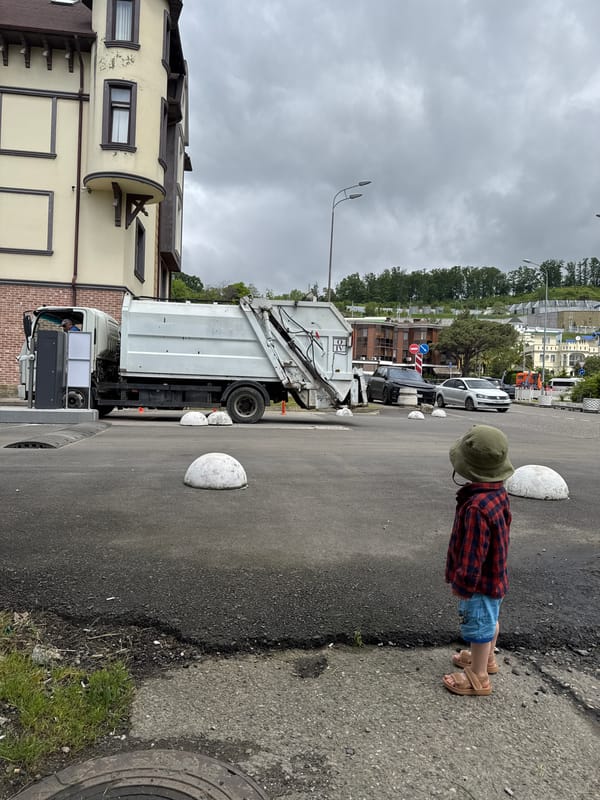Child stands on Sochi street during morning activity