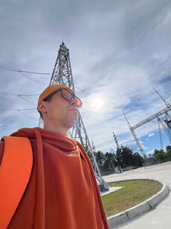Man gazes at power lines under cloudy sky in Chaikovsky