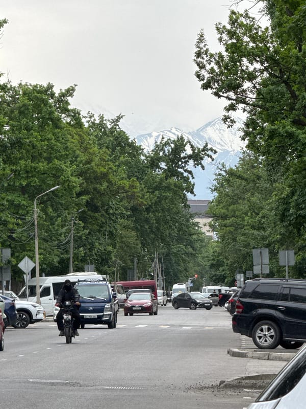 Motorcyclist navigates street traffic in Bishkek, Kyrgyzstan