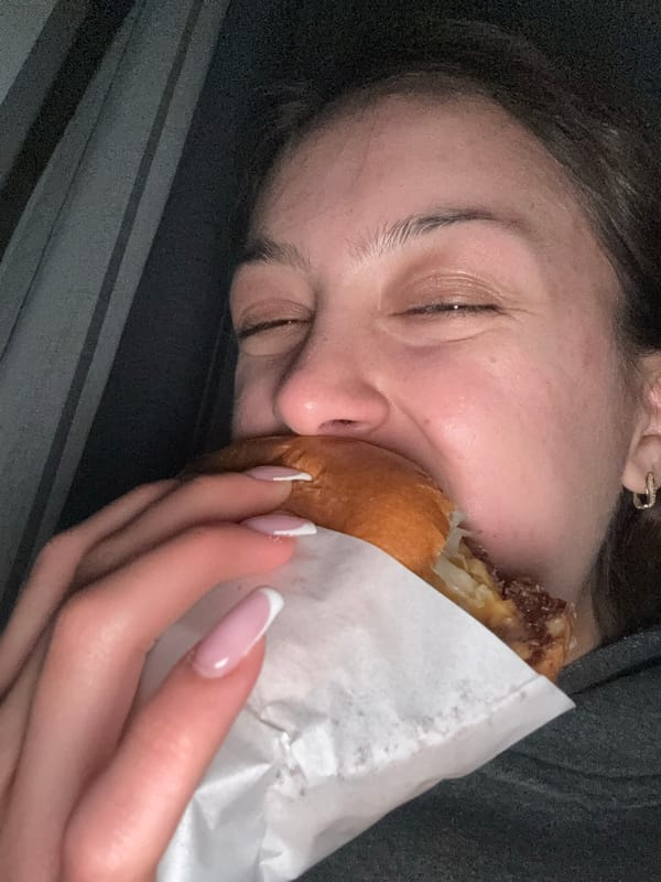 Person enjoys street food meal while lying down in Milan