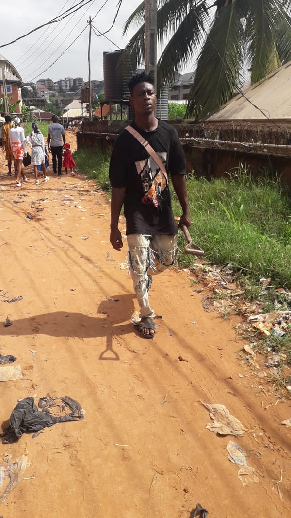 Morning street life along a dirt road in Nkpor, Nigeria