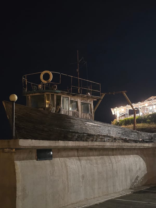 Weathered fishing boat at a quiet Bulgarian harbor at night