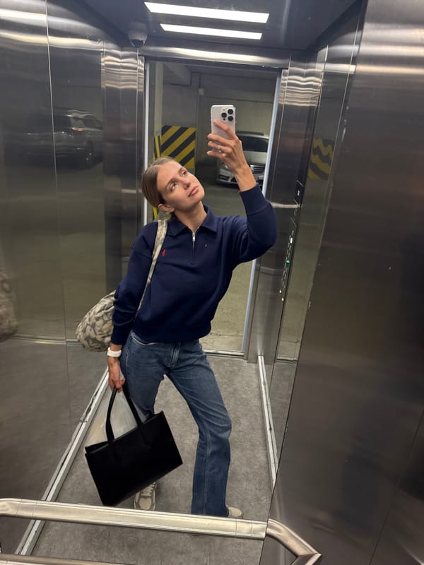Woman takes elevator selfies in stainless steel cabin