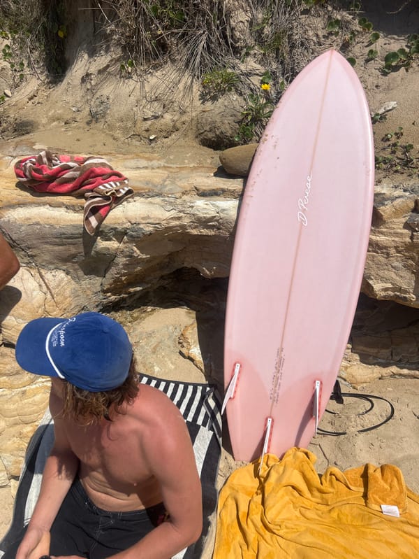 Late-night beach gathering recorded at Bulli with surfboards, towels