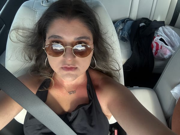 Woman relaxes in car in Hallandale Beach