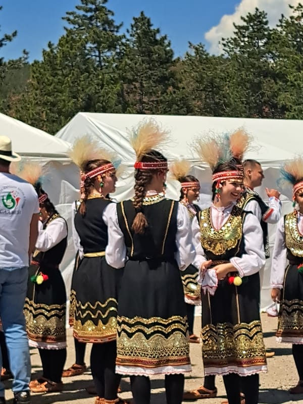 Bulgarian folk dancers perform traditional dance on outdoor stage