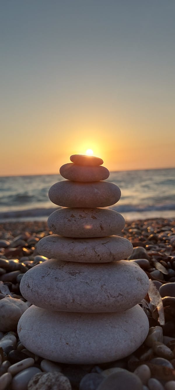 Seven smooth pebbles stacked in balance, Rhodes, Greece