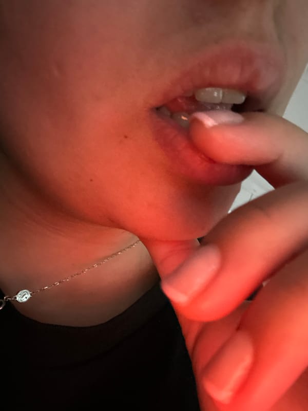 Person photographed with hand near mouth in Sofia