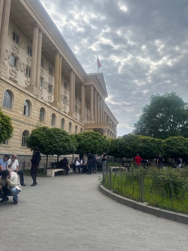 People gather near Georgian Parliament building in Tbilisi