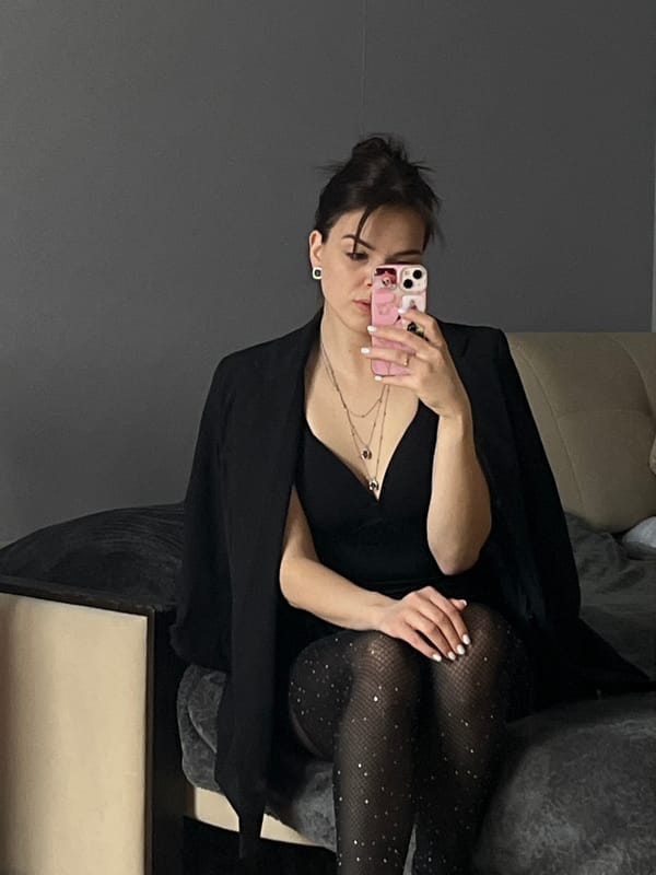 Woman takes mirror selfies with orange cat in Shushary