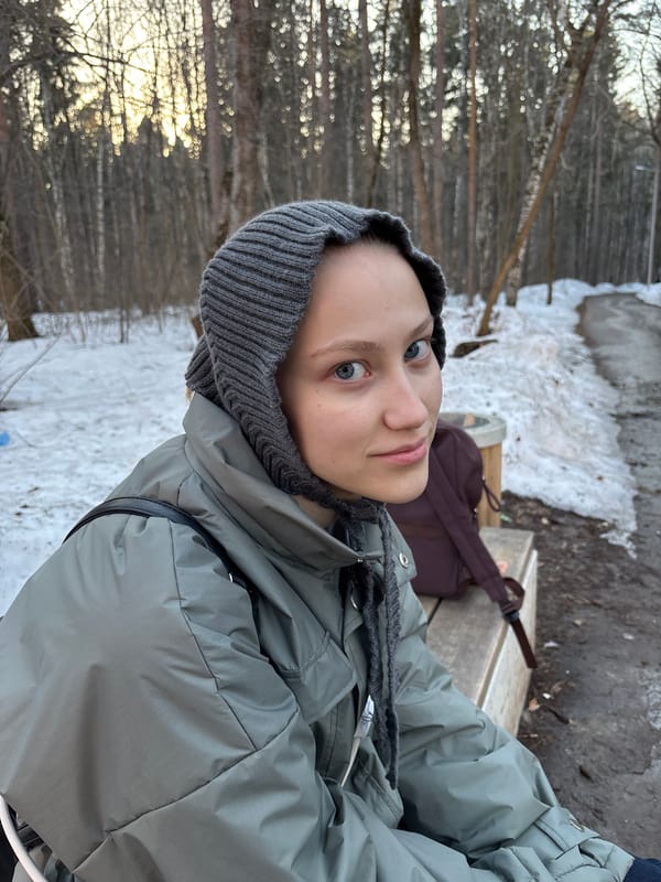 Woman collects moss in snowy Perm forest with dog