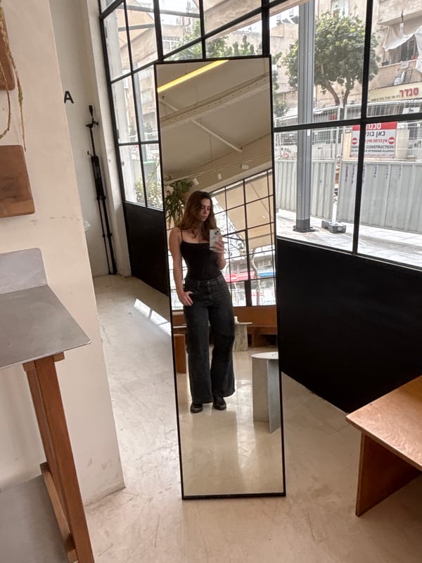 Person takes mirror selfie in Tel Aviv indoor location