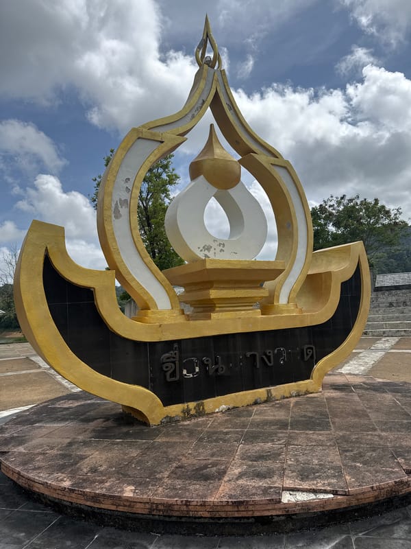 Gold-white monument with Thai script documented in Kathu, Thailand