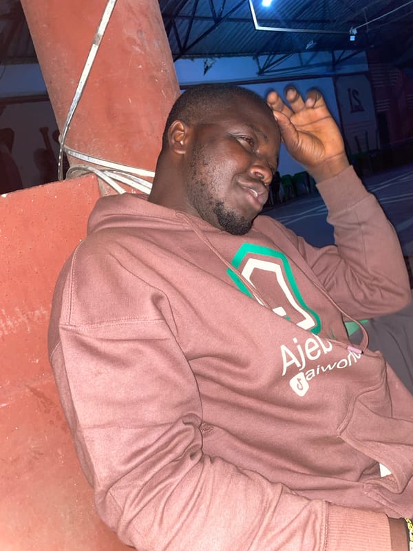 Man in brown hoodie lies on red tiles in Jos