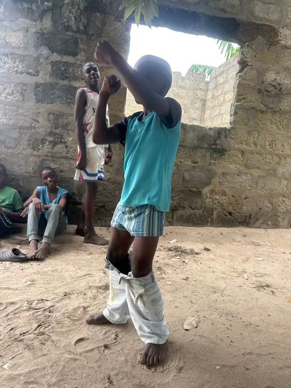Kids playing in sandy Badagry neighborhood on a June afternoon