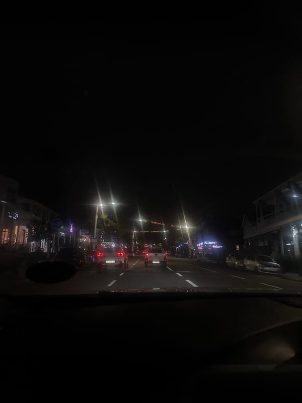 Evening traffic flows through illuminated Durban streets