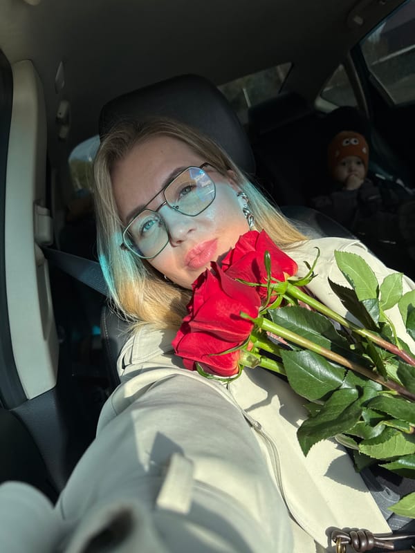 Woman takes selfie with red roses in Chaikovsky