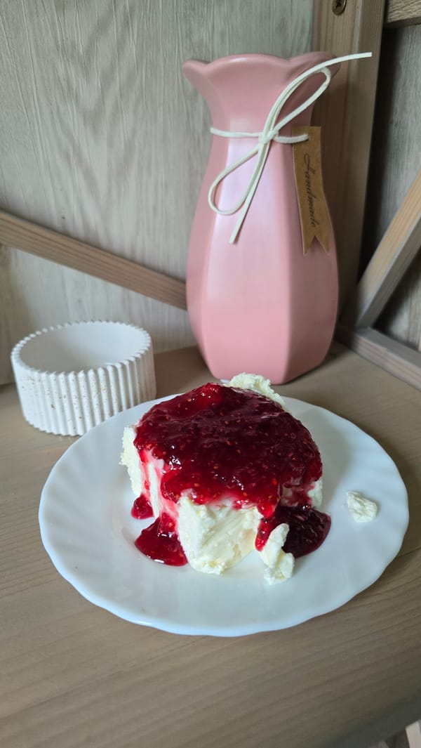 Cream cake with raspberry jam on a wooden table, Kyiv