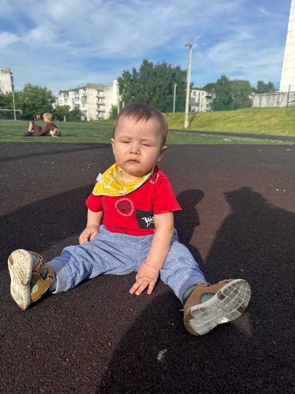 Afternoon hangout on a turf field with kids and a baby