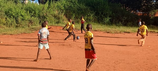 Children play games under adult supervision in Ngalula, DRC