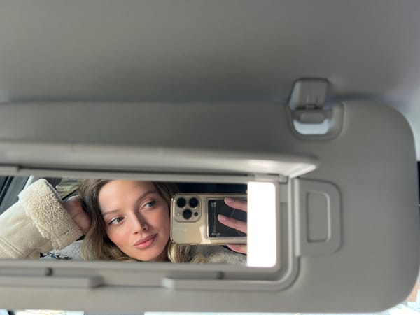 Woman takes selfie using car mirror in Chaykovsky