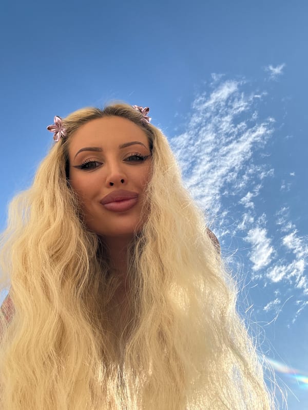 Low-angle portrait against a bright blue sky
