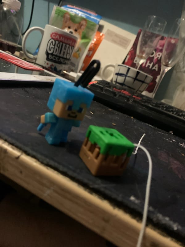 Kolpino home desk, RGB gear, Minecraft figures, and a pug