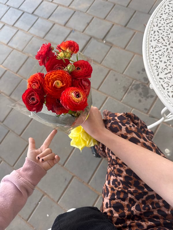 Mother and child share Friday morning flowers in Bat Yam