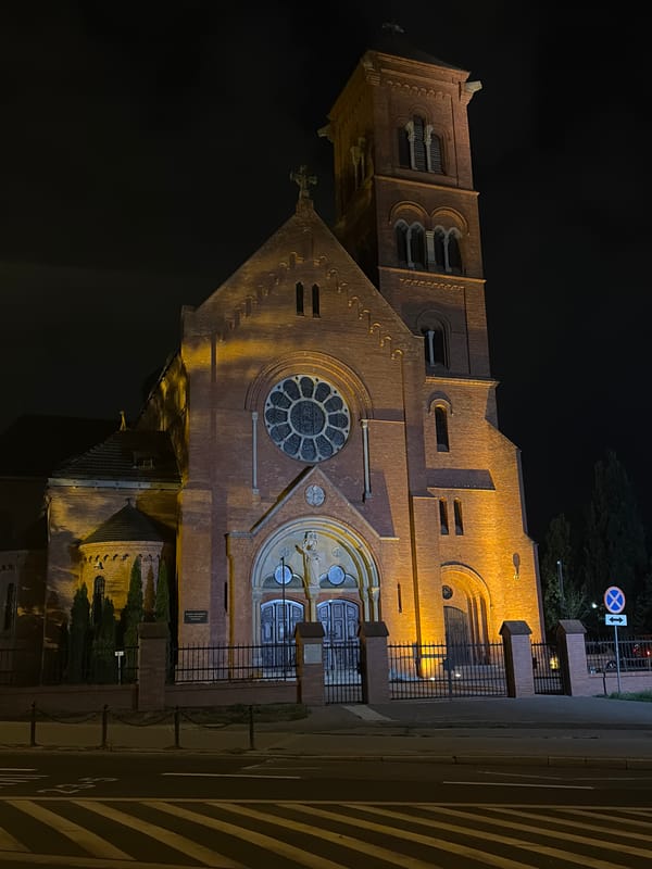 Poznań streets and a lit church on a summer night