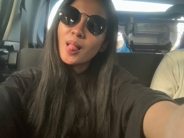 Family takes playful selfies during car trip in Indonesia