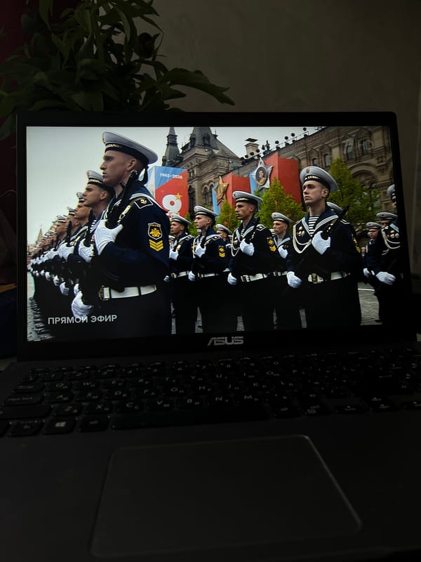 Resident watches Moscow military parade broadcast on laptop