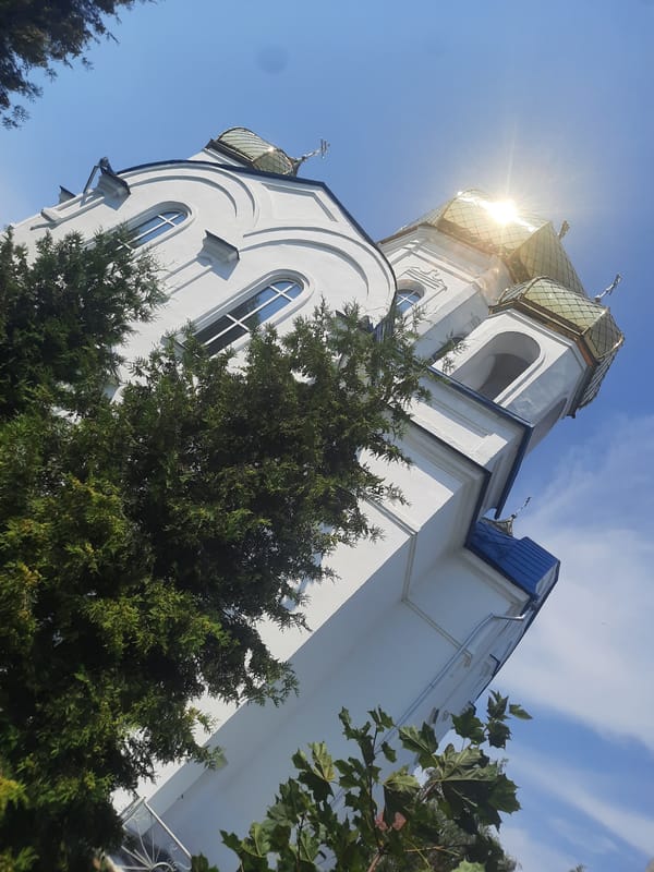 Flowers and golden domes at a Shklov Orthodox church