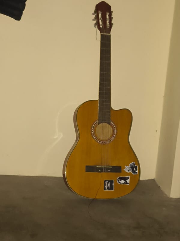 Acoustic guitar session in a Haini bedroom during a rainy morning