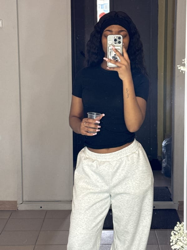 Woman takes mirror selfie while holding cup in Troitsk