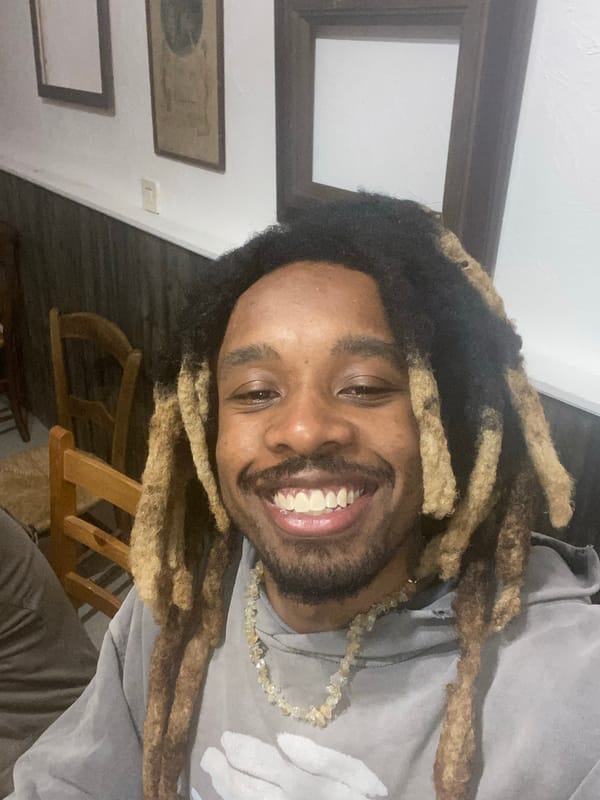 Young man captures smiling selfie in French Alps village