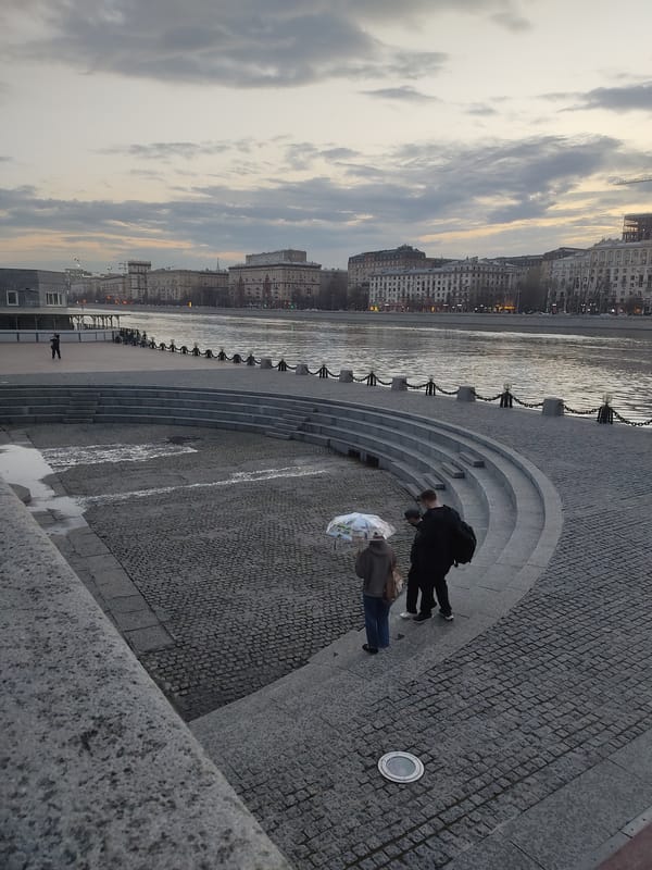 Moscow river embankment scene captured with urban buildings backdrop