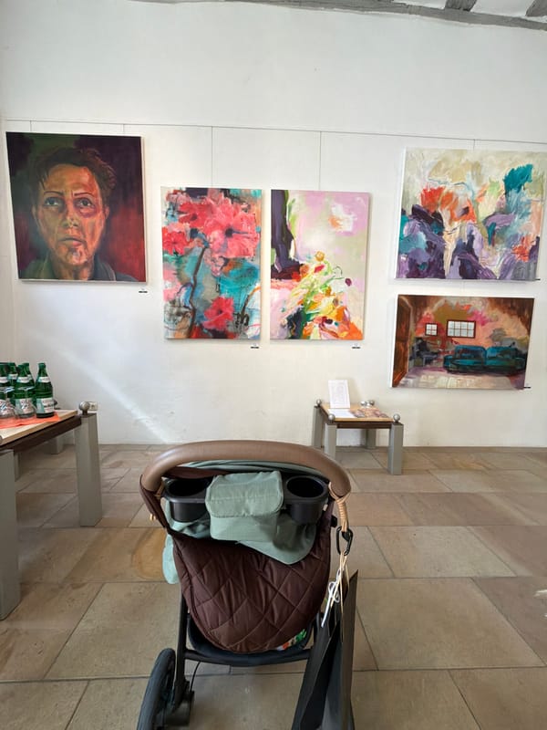 Art exhibition displayed alongside stroller in Meisenheim building