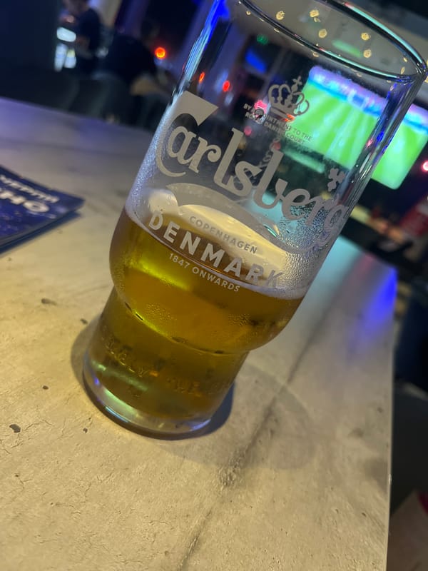 Soccer match viewing session at sports bar with drinks