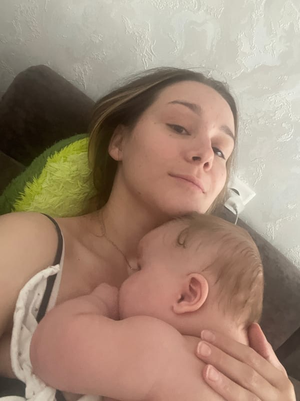 Quiet indoor moment holding a sleeping baby in Stavropol