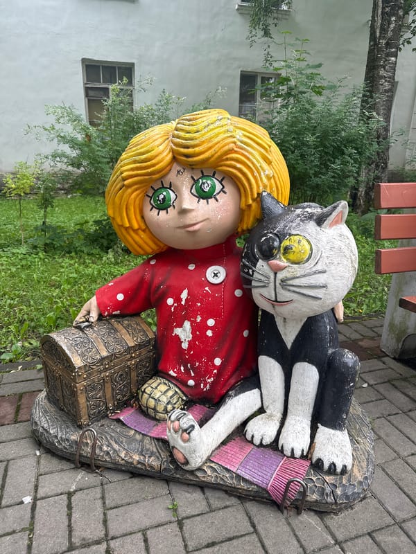 Folk art witch sculptures spotted in a Slantsy courtyard