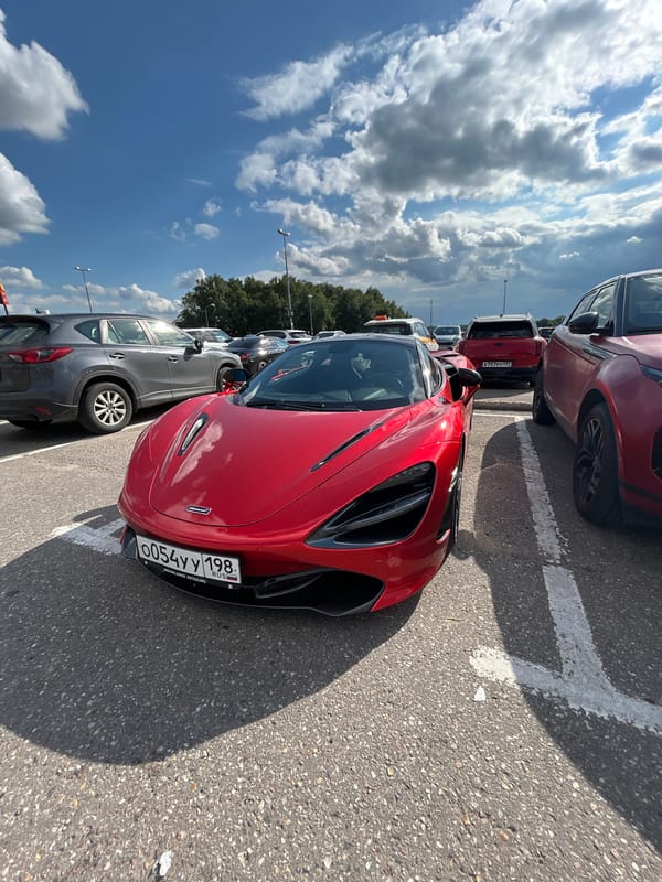 Red McLaren parked in a lot outside Pokrovskoe, Russia