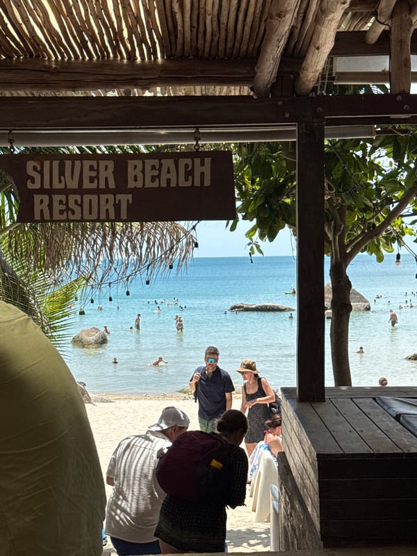 Sunny day at Silver Beach Resort, boulders, water, and shoreline