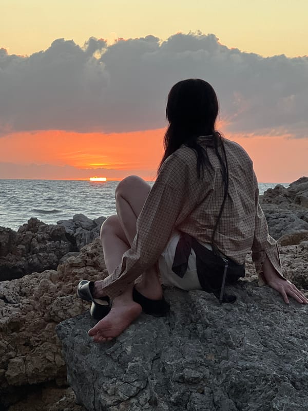 Sunset watchers gather on Palermo's rocky coastline Mediterranean evening