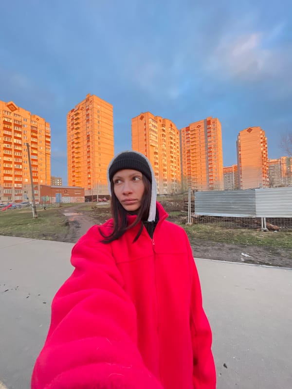 Woman photographed with dog in urban Izhevsk setting