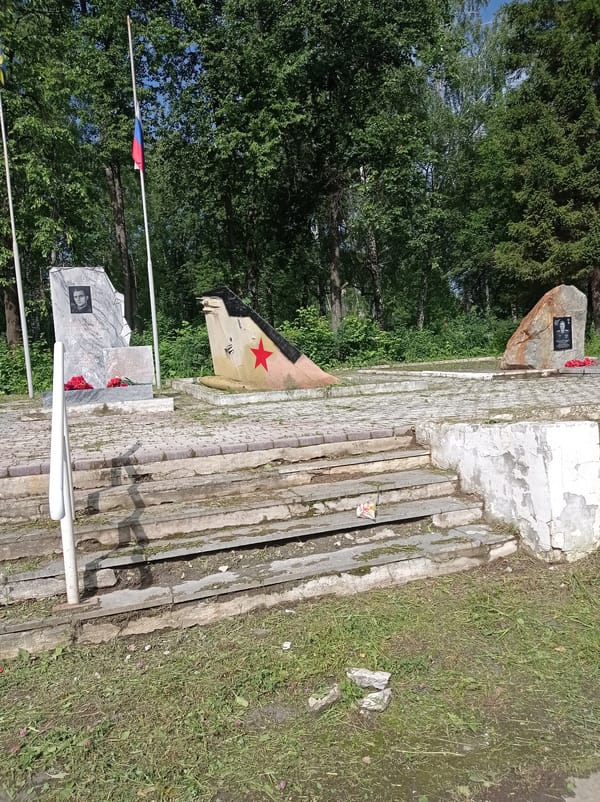 Degtyarsk's memorials and main street shops, a June morning