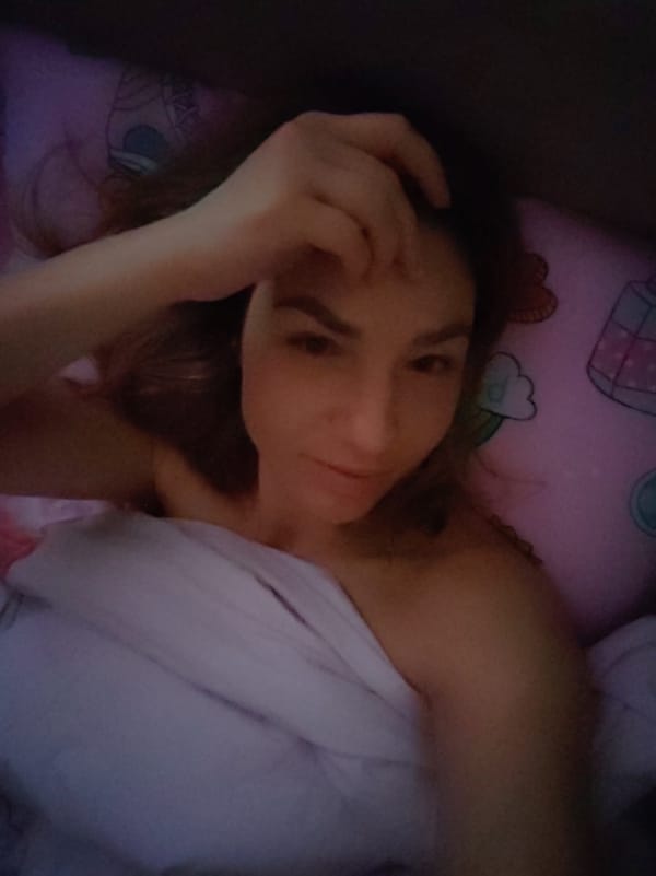 Woman captures morning selfie in Saint Petersburg bedroom