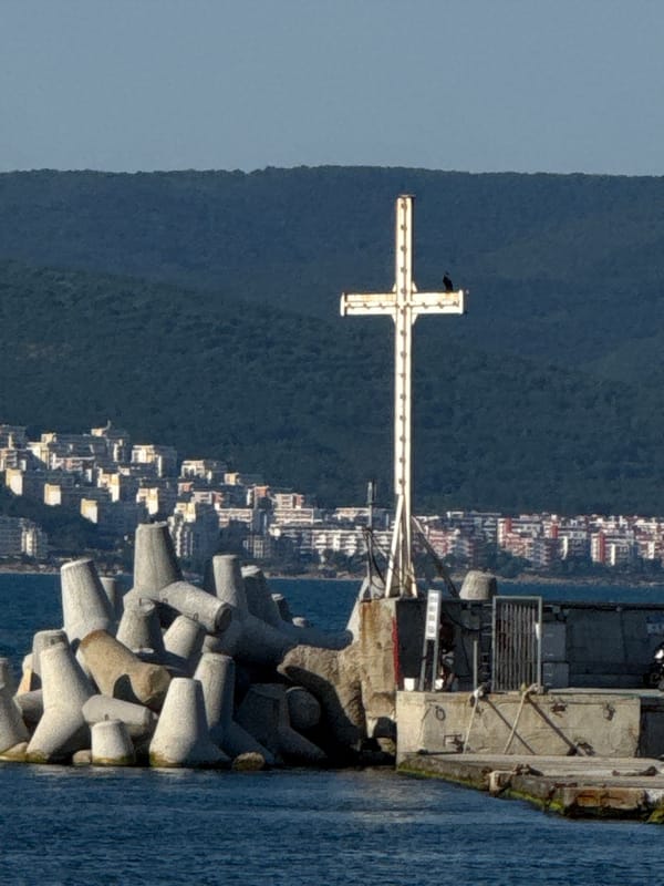 Nesebar's harbor promenade: windmill, pier cross, and summer boats