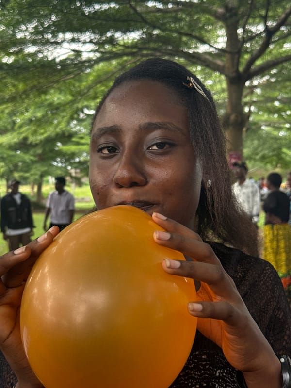 Women gather with balloons outdoors in Ihiagwa, Nigeria